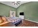 Bedroom features vaulted ceilings, wood floors, a ceiling fan, and an ensuite bathroom at 2601 Bridle Dr, Plant City, FL 33566