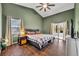 Bedroom features vaulted ceilings, a ceiling fan, wood floors, and access to the screened lanai at 2601 Bridle Dr, Plant City, FL 33566