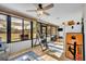 Enclosed sunroom with tile floors, ceiling fans, and large windows offering natural light and backyard views at 2601 Bridle Dr, Plant City, FL 33566