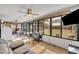 Bright sunroom features tile flooring, ceiling fans and ample windows overlooking the spacious backyard at 2601 Bridle Dr, Plant City, FL 33566
