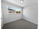 Bright bedroom with fresh neutral decor, large window, and plush carpeting at 4432 W Wallace Ave, Tampa, FL 33611