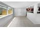 Inviting dining area with bright tile flooring, windows for ample light, and an open layout connected to the kitchen at 4432 W Wallace Ave, Tampa, FL 33611