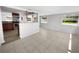 Bright dining area with modern tile flooring adjacent to an open kitchen layout, perfect for gatherings at 4432 W Wallace Ave, Tampa, FL 33611