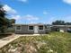 Charming home featuring a front yard with green grass and a neatly painted exterior with white trim at 4432 W Wallace Ave, Tampa, FL 33611