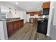 Modern kitchen showcasing wood cabinets, granite countertops, and stainless steel appliances for a sleek design at 4432 W Wallace Ave, Tampa, FL 33611