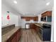 Modern kitchen showcasing wood cabinets, granite countertops, and stainless steel appliances for a sleek design at 4432 W Wallace Ave, Tampa, FL 33611