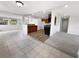 Open-concept living area with tile flooring connecting seamlessly to the kitchen with granite countertops at 4432 W Wallace Ave, Tampa, FL 33611