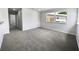 Spacious living room boasting plush gray carpeting and a bright, airy feel with natural light at 4432 W Wallace Ave, Tampa, FL 33611