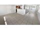 Bright open floor plan features tile flooring, and a view into the kitchen space with granite countertops at 4432 W Wallace Ave, Tampa, FL 33611