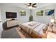 Cozy bedroom with ceiling fan, two windows, and natural light creates a peaceful retreat to enjoy a good night's rest at 4432 W Wallace Ave, Tampa, FL 33611