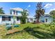 Spacious backyard with lush grass, shaded seating areas, and serene landscaping, ideal for outdoor living at 8407 Interbay Blvd, Tampa, FL 33616