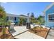 Landscaped backyard featuring a patio area, grill, outdoor seating, and lush greenery, perfect for entertaining at 8407 Interbay Blvd, Tampa, FL 33616
