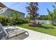Relaxing backyard featuring a patio, lounge chairs, a manicured lawn, mature landscaping, and privacy fencing at 8407 Interbay Blvd, Tampa, FL 33616