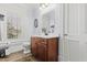Bright bathroom features a wood vanity, white countertop, and ample natural light from the window at 8407 Interbay Blvd, Tampa, FL 33616