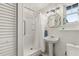 Bathroom featuring a standalone shower and modern pedestal sink at 8407 Interbay Blvd, Tampa, FL 33616