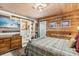 Bedroom with wooden accent wall and an ensuite bathroom at 8407 Interbay Blvd, Tampa, FL 33616