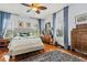 Cozy bedroom featuring hardwood floors, detailed rug, and plenty of natural light with large windows at 8407 Interbay Blvd, Tampa, FL 33616