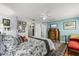 Comfortable bedroom with a floral bedspread, artwork, and wooden dresser at 8407 Interbay Blvd, Tampa, FL 33616