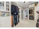 Spacious walk-in closet with ample storage, custom shelving, and multiple rods for organizing clothing at 8407 Interbay Blvd, Tampa, FL 33616