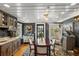 Cozy dining area with dark walls, custom cabinets, and a stylish round dining table at 8407 Interbay Blvd, Tampa, FL 33616