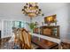Formal dining room with a long table, ornate chairs, and a view into the living area at 8407 Interbay Blvd, Tampa, FL 33616