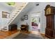 Grand entryway with hardwood floors, staircase, and a glimpse into an adjoining room at 8407 Interbay Blvd, Tampa, FL 33616