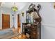 Elegant foyer featuring a vintage mirror cabinet, hardwood floors, and a decorative chandelier at 8407 Interbay Blvd, Tampa, FL 33616