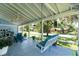 Spacious covered porch featuring a porch swing, ceiling fans, and comfortable seating at 8407 Interbay Blvd, Tampa, FL 33616