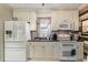 Well-lit kitchen with white cabinets, a double oven, and a unique backsplash at 8407 Interbay Blvd, Tampa, FL 33616