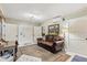 Cozy living room with a comfortable leather sofa, vintage rug, and light green walls at 8407 Interbay Blvd, Tampa, FL 33616