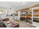 Open-concept living space with kitchen, dining area, TV, and a comfortable leather sofa at 8407 Interbay Blvd, Tampa, FL 33616