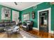 Stylish living room with green walls, hardwood floors, modern seating, and decorative accents at 8407 Interbay Blvd, Tampa, FL 33616