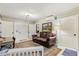 Cozy living room featuring wood-paneled walls, hardwood floors, and a comfortable leather sofa at 8407 Interbay Blvd, Tampa, FL 33616