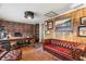 Inviting home office featuring wood paneling, built-in bookshelves, and a comfortable leather couch at 8407 Interbay Blvd, Tampa, FL 33616