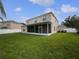 Large backyard featuring a screened lanai, lush lawn, and privacy fence at 11356 Callaway Pond Dr, Riverview, FL 33579