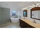 Bathroom features a soaking tub, glass-enclosed shower, and double vanity sinks with custom cabinetry at 11356 Callaway Pond Dr, Riverview, FL 33579
