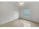 This bright bedroom features tile flooring, a closet, crown molding, and a large window at 11356 Callaway Pond Dr, Riverview, FL 33579