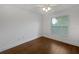 Well-lit bedroom with hardwood floors, white walls, and a window with blinds at 11356 Callaway Pond Dr, Riverview, FL 33579