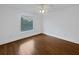 Bright bedroom with hardwood floors, white walls, and a window with blinds at 11356 Callaway Pond Dr, Riverview, FL 33579