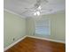 Bedroom with hardwood floors, neutral paint, window, and fan at 11356 Callaway Pond Dr, Riverview, FL 33579