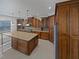 Well-lit kitchen features custom cabinets, a granite countertop island with pendant lighting, and stainless steel appliances at 11356 Callaway Pond Dr, Riverview, FL 33579