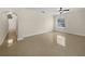 Spacious living room with glossy tile flooring and archway leading to staircase at 11356 Callaway Pond Dr, Riverview, FL 33579