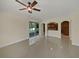 Open living room with archways, sliding glass door and glossy tile flooring at 11356 Callaway Pond Dr, Riverview, FL 33579