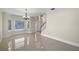 Bright living room with tile floor, staircase and large front window at 11356 Callaway Pond Dr, Riverview, FL 33579