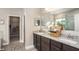 Elegant bathroom featuring double sinks, granite countertops, and a walk-in closet at 11456 Libby Rd, Spring Hill, FL 34609