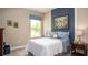 Bright bedroom features baseball-themed decor, complementing the neutral walls and white quilted bedding at 11456 Libby Rd, Spring Hill, FL 34609