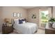 Relaxing bedroom offers neutral walls, plush carpet, and a large window with abundant natural light at 11456 Libby Rd, Spring Hill, FL 34609