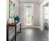 Inviting entryway with gray wood flooring, a decorative glass door, and neutral-toned walls at 11456 Libby Rd, Spring Hill, FL 34609