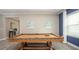 Game room features a billiards table, light wood floors, and natural light from a side window at 11456 Libby Rd, Spring Hill, FL 34609