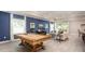 Spacious living room featuring a pool table and a comfortable seating area at 11456 Libby Rd, Spring Hill, FL 34609